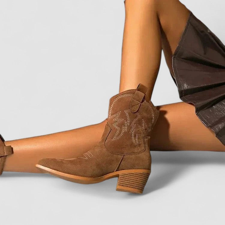 Lillian Western Comfort Boots by Bennett and Lowe featuring brown leather, decorative stitching, and sturdy heel on a wooden surface.