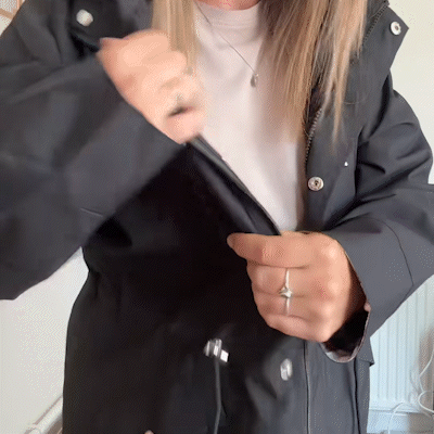 Black waterproof 3-in-1 raincoat for women with detachable hood by Bennett and Lowe, shown on a model.