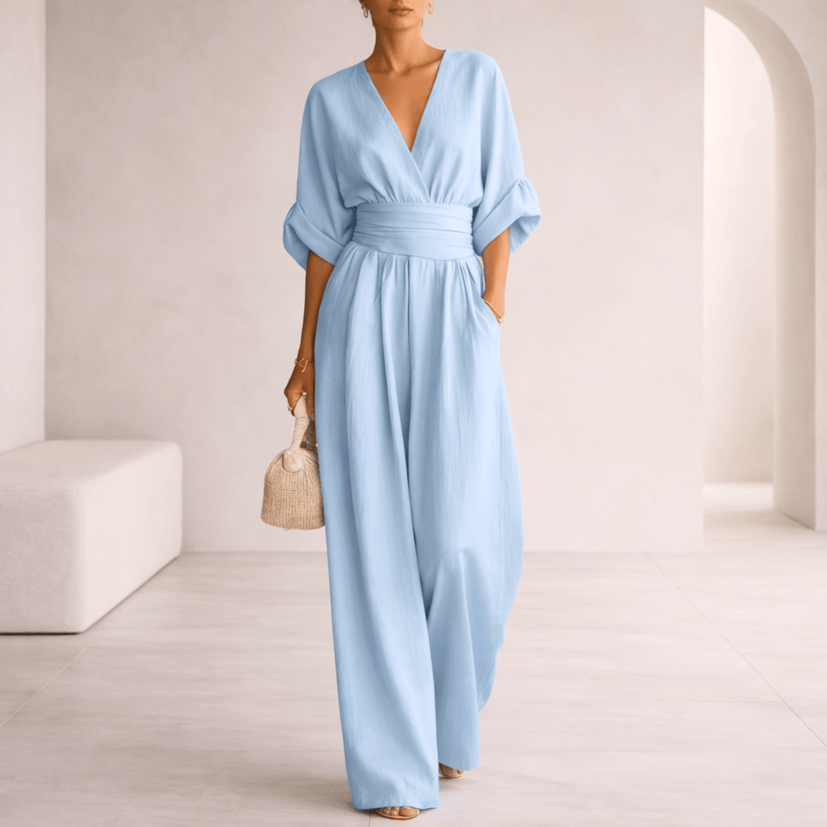 Elira Bennett and Lowe V-neck draped wide-leg jumpsuit for women, shown from the front with flowing fabric and wide-leg silhouette.